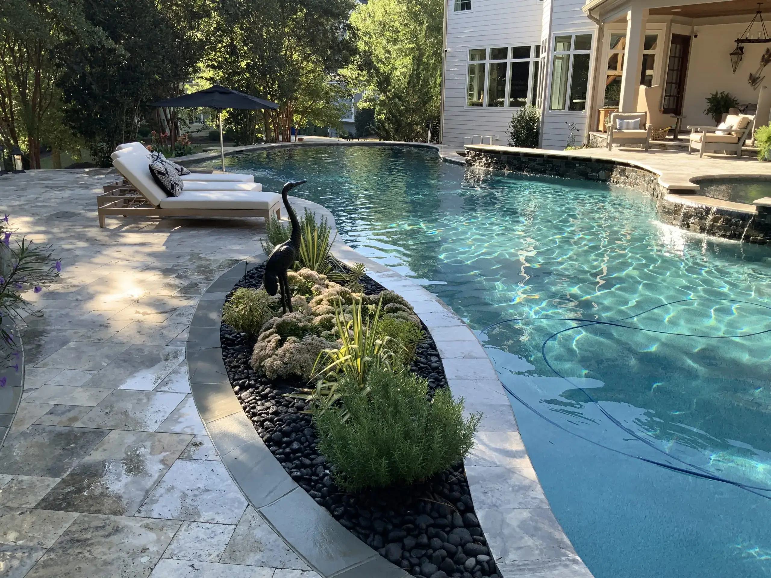 Raleigh swimming pool with travertine and planter