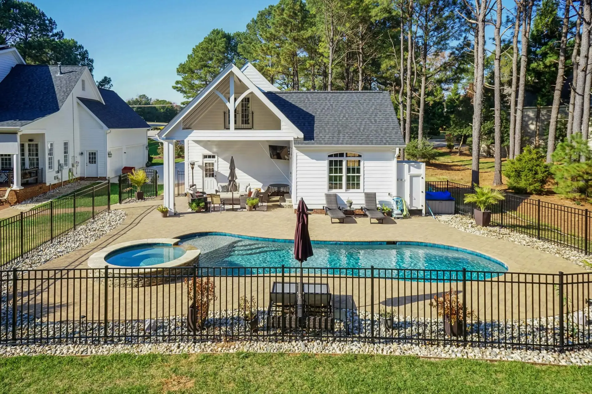 Custom Raleigh NC concrete freeform pool with paver pool deck - side view