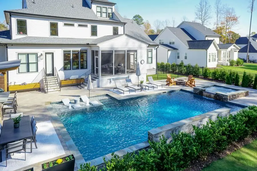 Raleigh, NC luxury rectangular pool with Cambridge pavers and lush landscaping