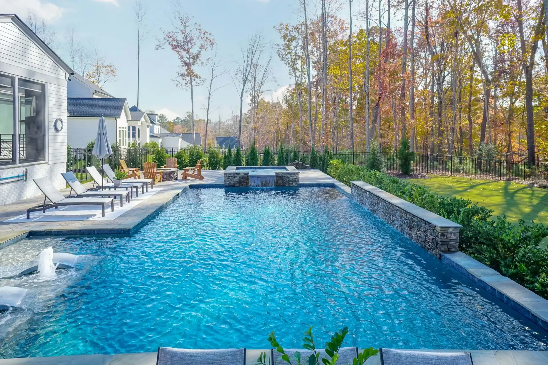 Rectangular custom concrete pool with end-spa in Raleigh, NC - long view
