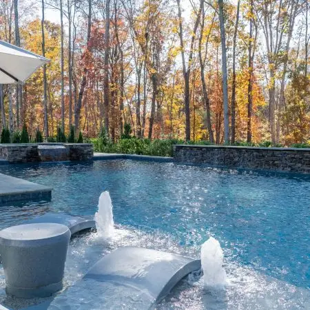 Weeping wall, tanning ledge, bubblers, and spa on custom North Raleigh pool