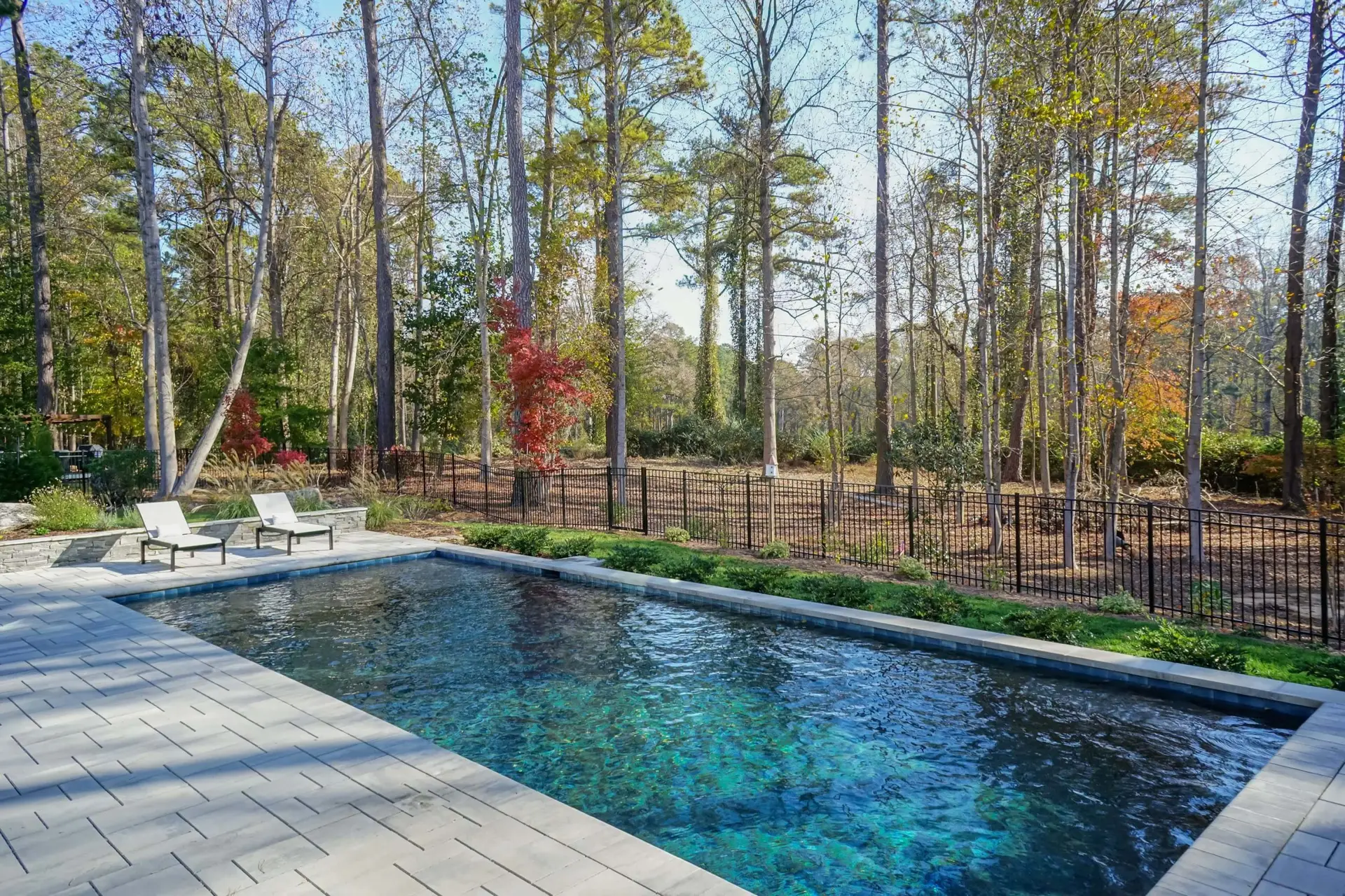 Wake Forest rectangular pool with Pebbletec plaster and Techo Bloc pavers