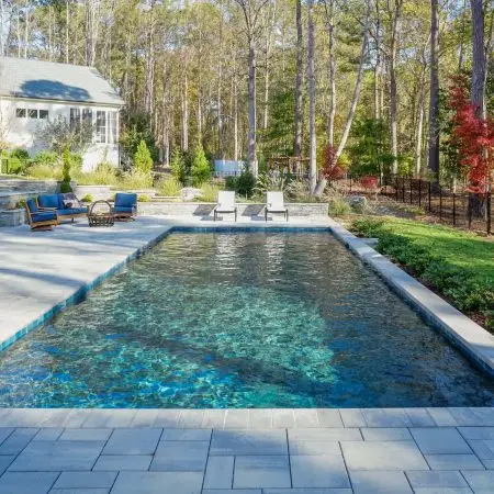 Wake Forest custom pool with Techo Bloc pavers, landscaping, and stone work