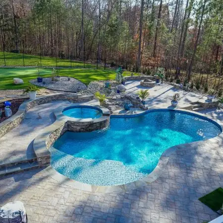 Custom Pool project in Pittsboro, NC with a freeform pool, spa, fire pit and waterfall.