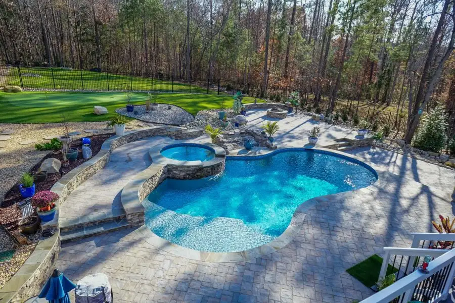 Custom Pool project in Pittsboro, NC with a freeform pool, spa, fire pit and waterfall.