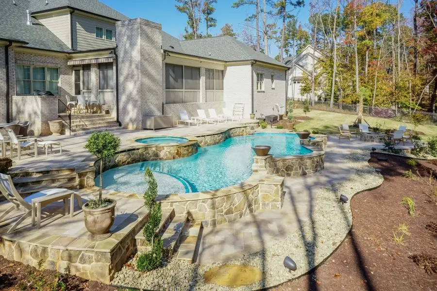 Wake Forest custom freeform pool with stonework, spa and firebowls