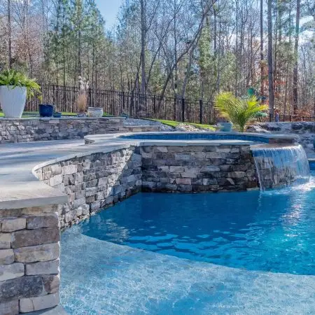 Custom stonework on freeform pool and spa in Pittsboro, NC