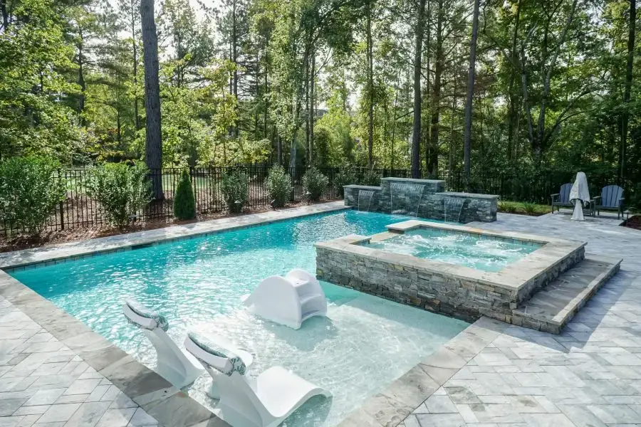 Toll Mill Vista Escape luxury custom linear pool with spa and water feature wall in Raleigh, NC
