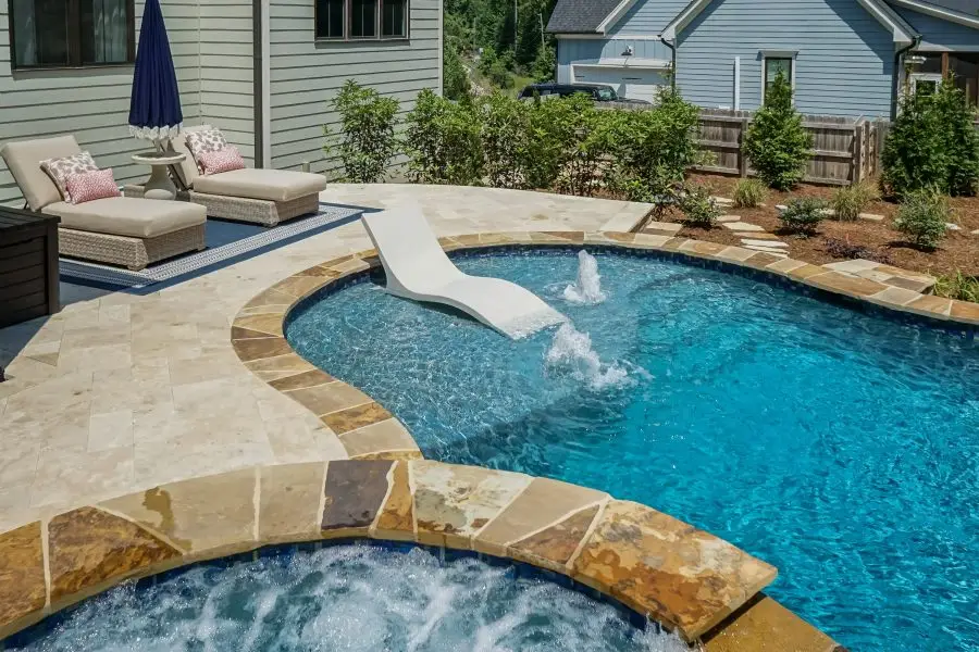 Custom tanning ledge on concrete freeform pool in Holly Springs, NC
