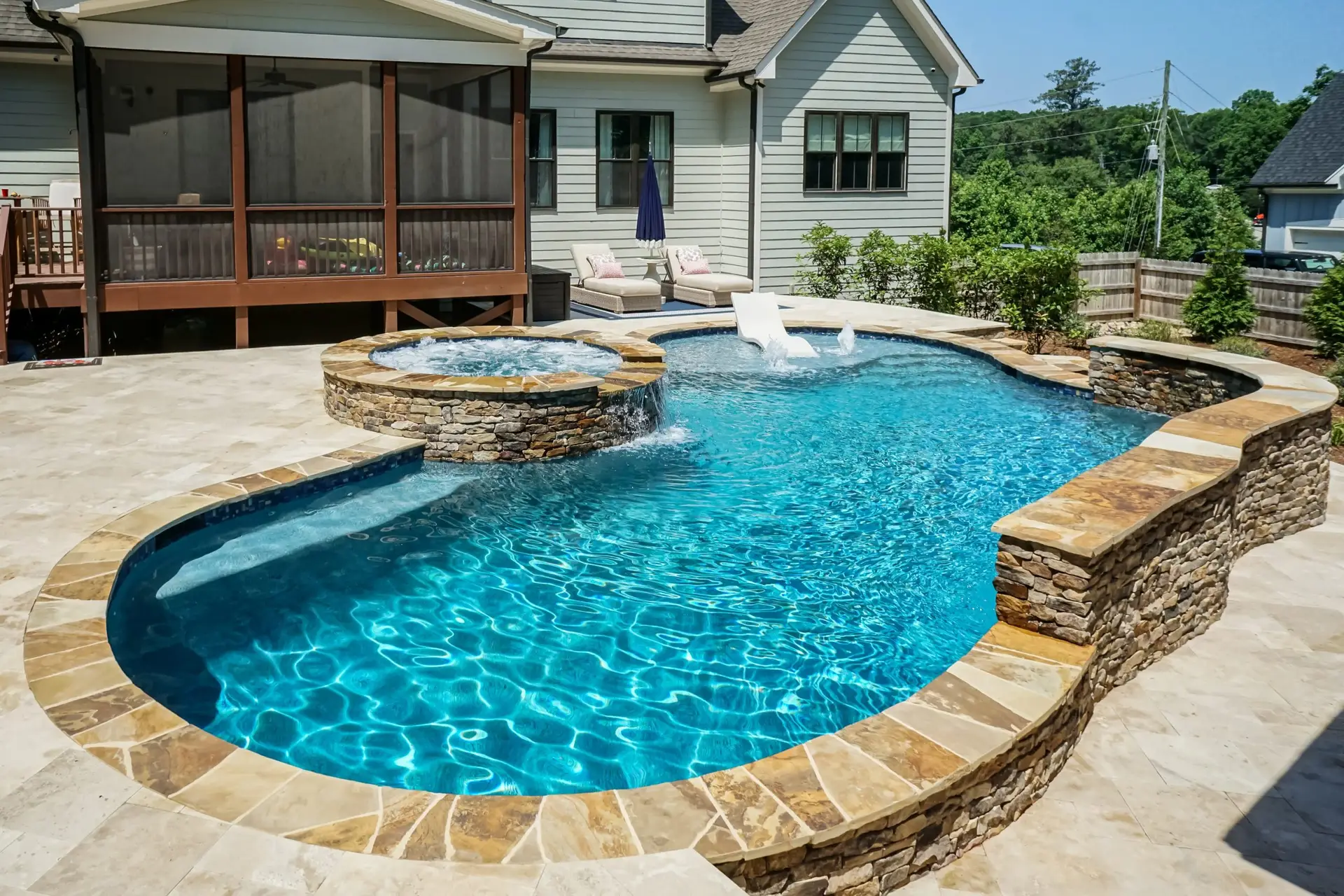 Luxury custom concrete Holly Springs pool with spa
